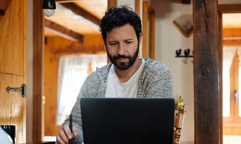 Man using laptop at home.